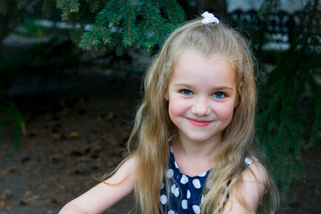 little blonde girl. Portrait of a beautiful smiling girl outdoor. Summer portrait of a smiling girl. 