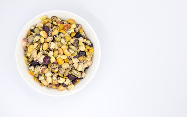 Colorful kidney bean in white ceramic bowl top view. Healthy food banner template with text place. Kidney bean ornament