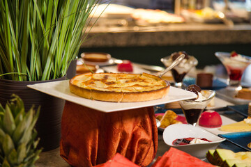 Cheesecake on a buffet table full of desserts