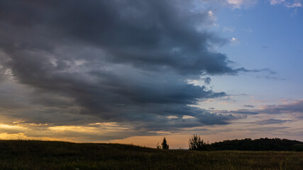 Evening sky and rain clouds, countryside landscape.