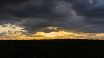 Evening sky and rain clouds, countryside landscape.