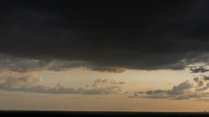 Evening sky and rain clouds, countryside landscape.