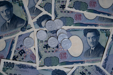Fototapeta na wymiar Background of Japanese yen 1000, 5000 and some coins, Spread of Japanese yen note.