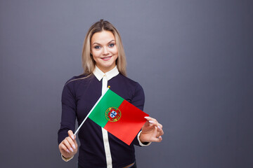 Immigration and the study of foreign languages, concept. A young smiling woman with a Portugal flag...