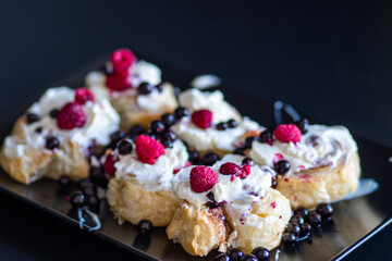 Cinnamon rolls with berries and whipped cream