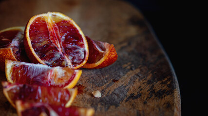 Slices of red oranges on wooden Board