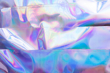 high res full frame macro photo of abstract pastel iridescent holographic foil background with...