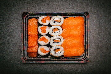 stock photography assorted rice sushi inside three tupper black reusable tray on gray background