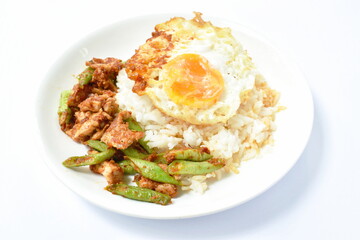 spicy fried pork with slice yard long bean in curry on rice topping egg