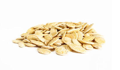 Group of salty pumpkin seeds in shell isolated on white surface. Snack food ready to eat
