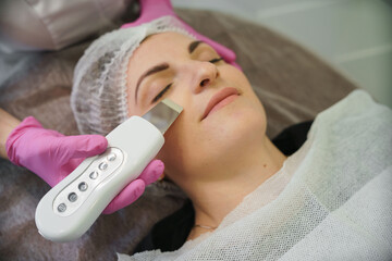 Girl beautician does facial massage, healthy skin, skin care.