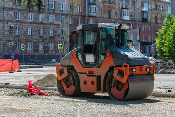 Paver in the process of leveling the ground of the road, for road surface