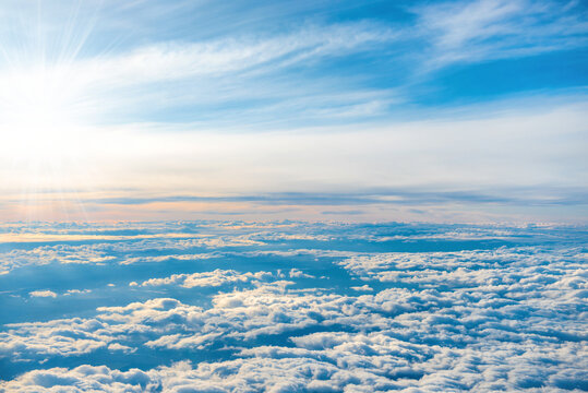 Aerial view of blue sky with layers of white fluffy cumulus and cirrus clouds © Pavlo Vakhrushev