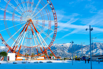 Batumi, Adjara, Georgia - 12.03.2020 : Ferris Wheel against Blue Sky in Black Sea, Batumi, Georgia in the winter