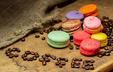 Macaroon with coffee on wood background