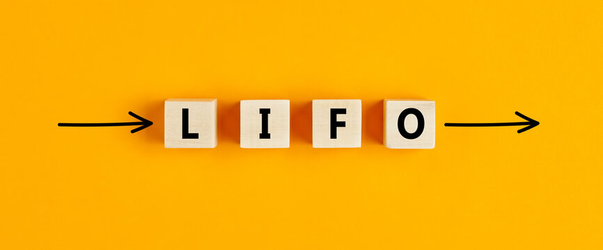 The business abbreviation lifo (last in first out) written on wooden blocks with directional arrows