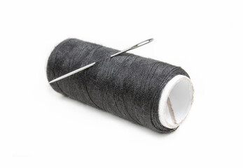 Needle and black thread isolated on white background. 