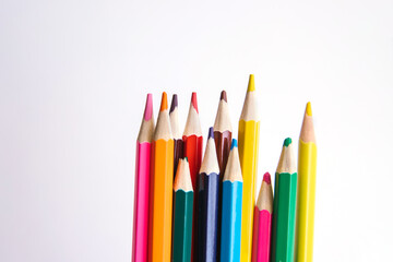 Colored pencils on a white background. Variety of colors. School supplies.