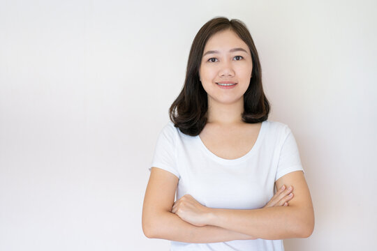 Portrait Of Asian Beautiful Woman Age Around 25 - 30 Years Old On White Background With Copy Space. Confident Asian Young Adult Portrait In Thoughtful Emotion.