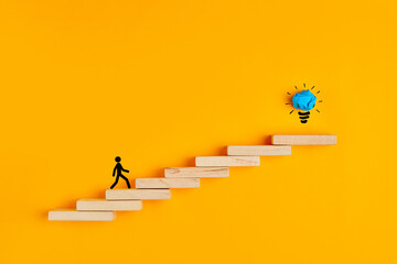 Stickman climbing steps towards the light bulb. Concept of success, creativeness or idea formation.