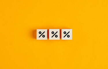 Percent signs on wooden cubes. Concept of discount and sale.