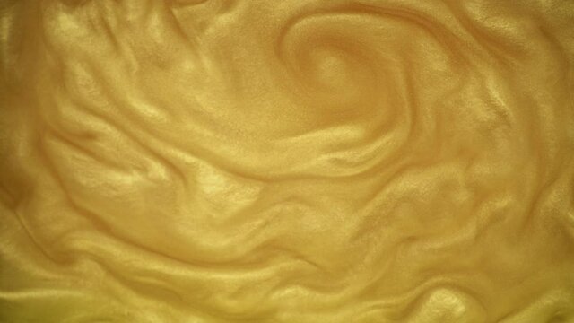 Gold background or texture of gold dust in water