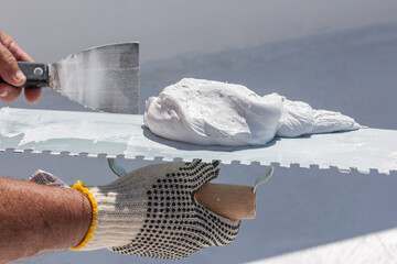 Builder using plastering tool for finishing wall and floor.
