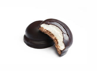 Two chocolate covered marshmallows isolated on white background. One with bite on it