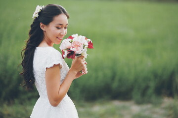 Beautiful bride holds a bouquet in her hands. Wedding. Bridal bouquet. Happy love concept.