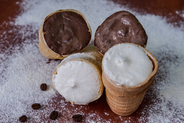 Chocolate and cream ice cream in a glass. Cold dessert Brown and white ice cream with coffee beans.