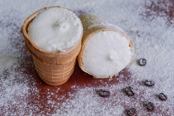 White cream ice cream in a waffle cup. Cream. Simple cold dessert