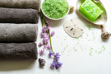 SPA decoration - towels, green salt, flowers, soap, seashells