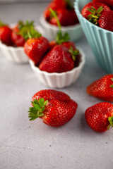 Strawberries on the table top view. Red berries pattern. Strawberry crop. Food still life in the spotlight. Red berry background.