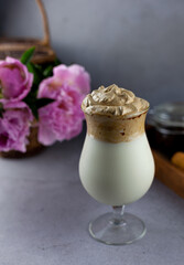 Milk shake. Chocolate and coffee sweet chilled ice-cream drink. Summer drink on the table in a glass goblet on a leg. Bar drinks.