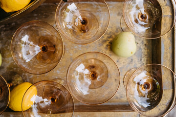 Glass coupes top view placed on a vintage metallic tray, outdoors.