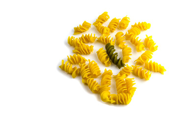 uncooked colored pasta on a white background cocept