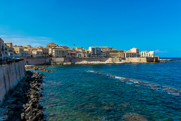 A view along the shoreline towards Fort Vigliena on Ortygia island in Syracuse, Sicily in summer