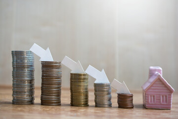 pile money coins saving trend decrease set with house model for concept investment mortgage fund...