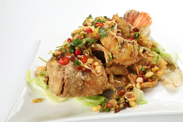 Deep fried freshwater red whole tilapia fish sliced fillet with Thai style lemongrass coriander shallot sauce