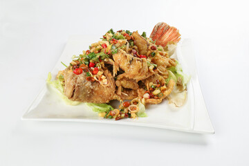 Deep fried freshwater red whole tilapia fish sliced fillet with Thai style lemongrass coriander shallot sauce