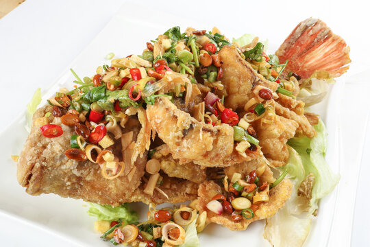 Deep fried freshwater red whole tilapia fish sliced fillet with Thai style lemongrass coriander shallot sauce