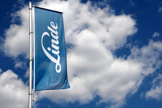Bonn, North Rhine-Westphalia / Germany - May 14, 2019: Flag with the logo of Linde AG against blue sky in Bonn, Germany - The Linde Group is a multinational chemical company