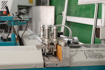 Machine cutting pvc profile. Production of PVC windows, a section of PVC plastic profile on the frame machine.