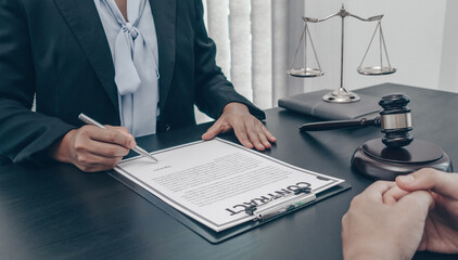 Asian female lawyer or lawyer is discussing a case with a male client in the room.