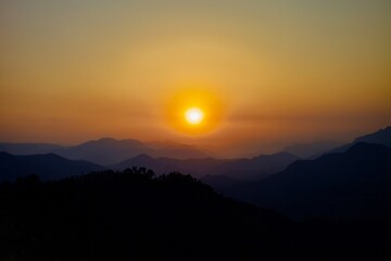 Majestic colorful sunrise in Nepal Himalayan mountains. Mountains ranges on Beautiful golden sunrise background. Panoramic Scenic sunrise view.  Mountains ranges and Bright colorful clear morning sky.
