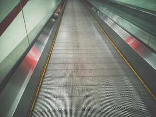 Fototapeta premium Escalator in Community Mall, Shopping Center. Moving up staircase. electric escalator. Close up to escalators.