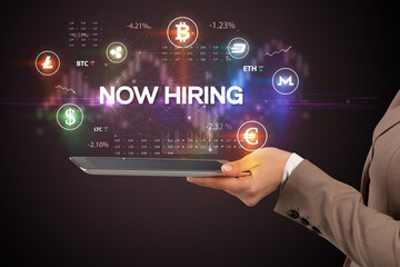 Close-up of a touchscreen with NOW HIRING inscription, business opportunity concept