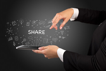 Close-up of a touchscreen with SHARE inscription, social media concept