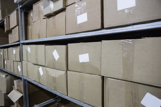 Cardboard boxes on warehouse shelves