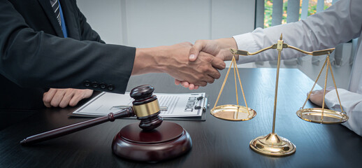 Lawyers or attorneys shake hands to congratulate the clients who have proceeded the matter with...